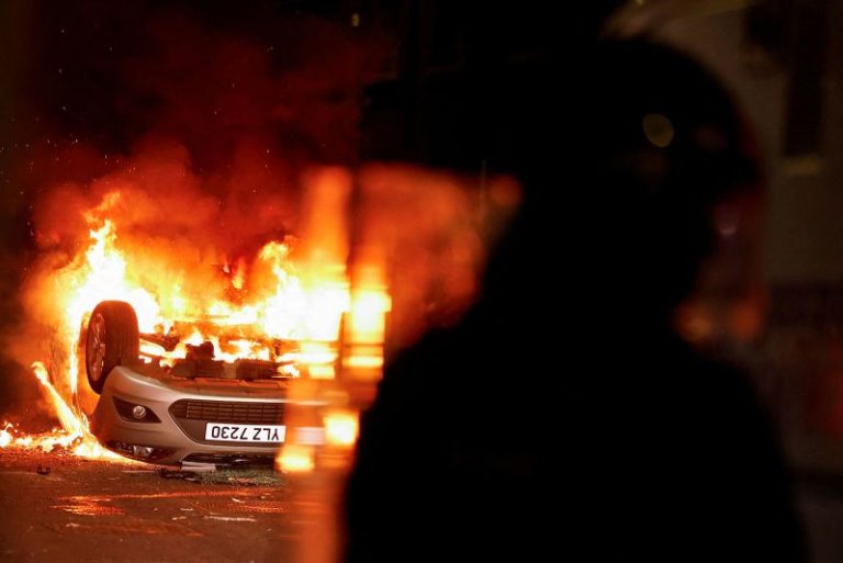 Masked rioters in Northern Ireland attack police, torch houses for second night